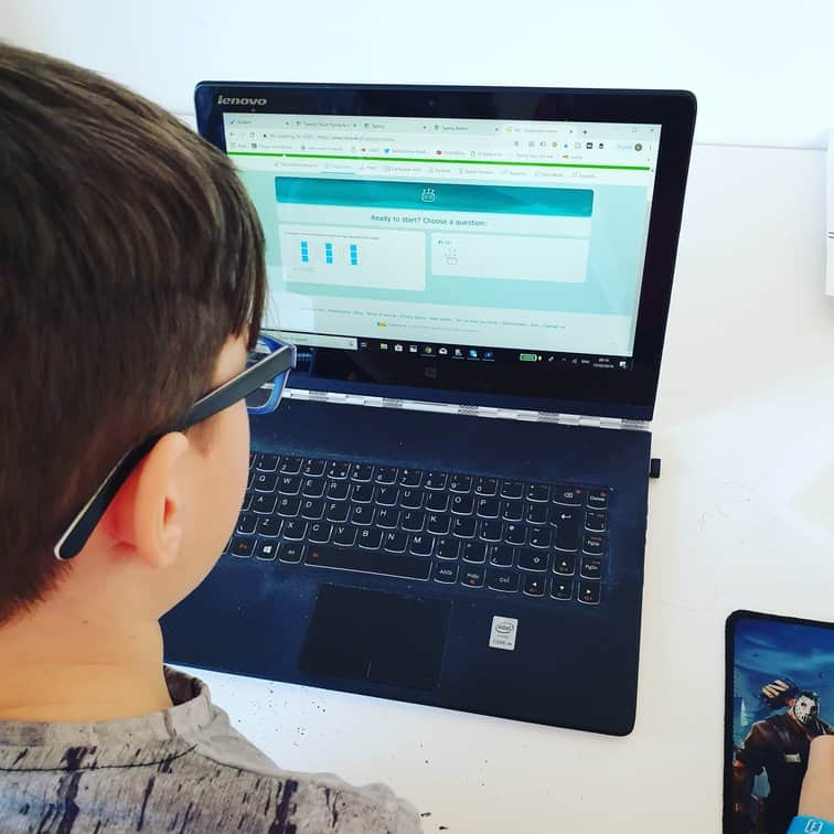 Boy using IXL on a laptop at home