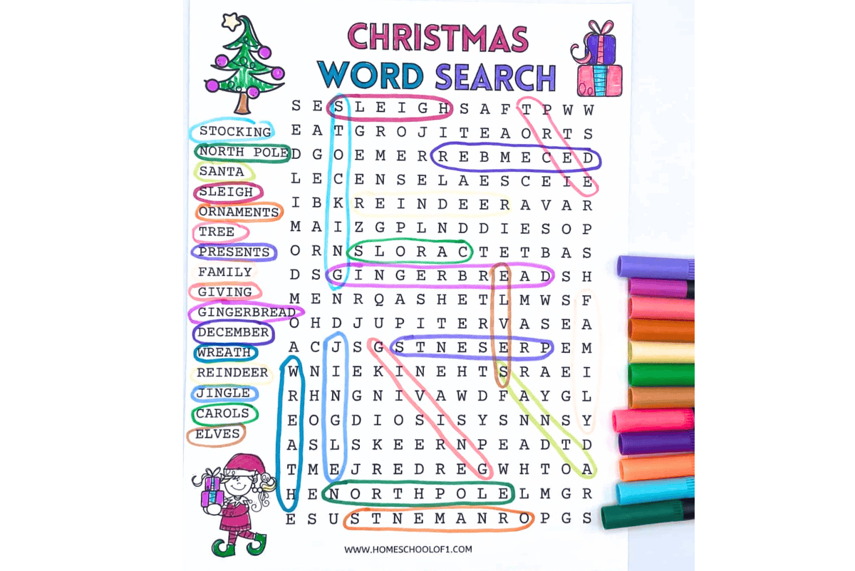 Christmas word search printable for kids with 16 holiday-themed words highlighted and colorful markers beside the worksheet.