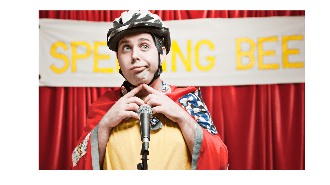 boy wearing a helmet looking confused at a spelling bee