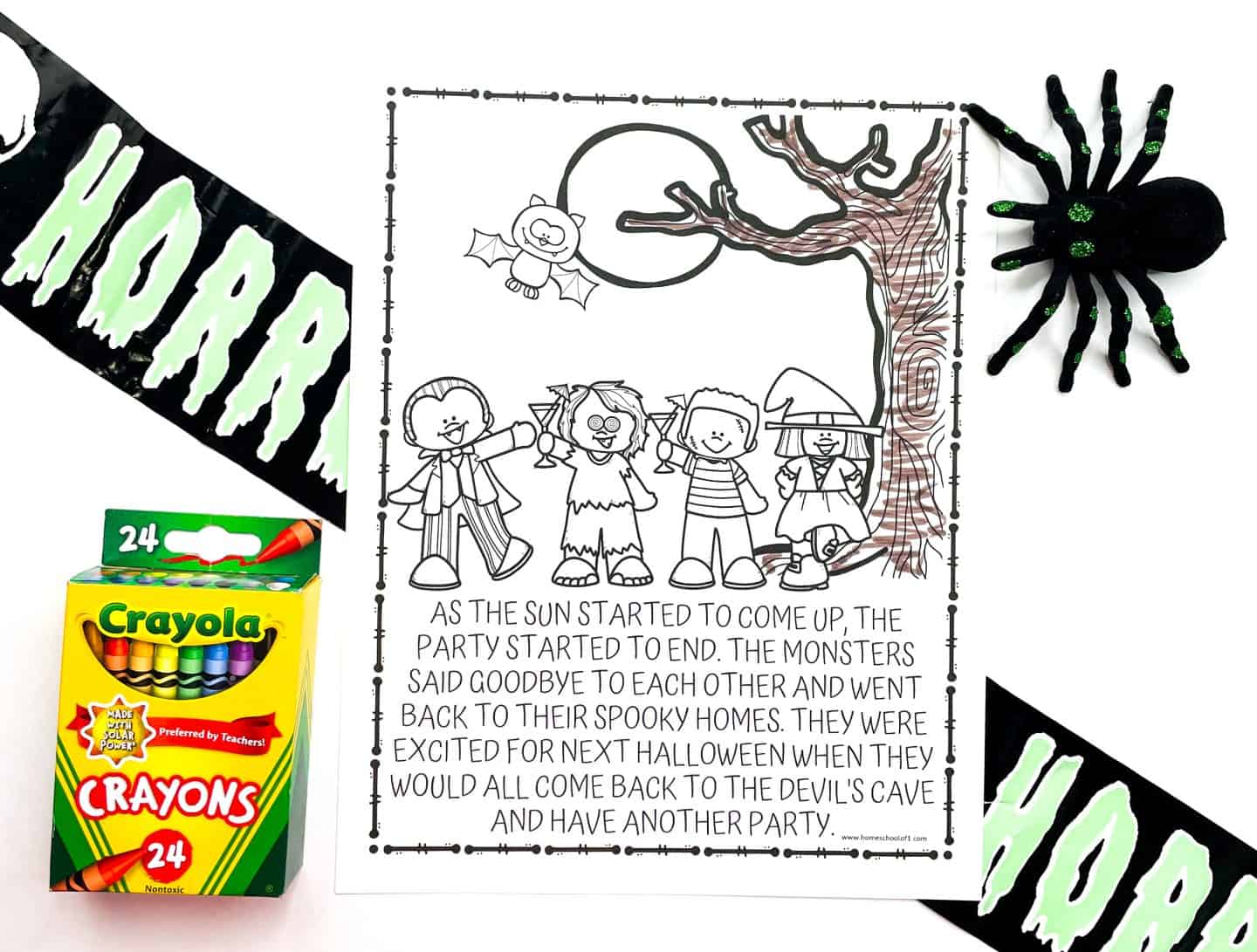 A Halloween coloring page features a group of children in costumes—vampire, monster, pirate, and witch—standing beneath a full moon and a large tree, which is partially colored in brown. The story at the bottom describes the end of a Halloween party and the monsters returning to their homes. The page is surrounded by props: a Crayola 24-pack of crayons, a glittery black spider, and black caution tape labeled “HORRORZONE” in green, creating a fun and spooky scene.