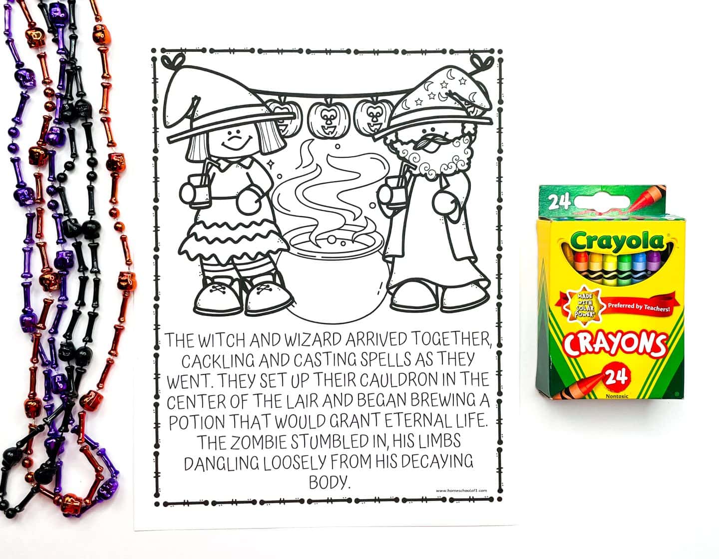 A Halloween coloring page for kids features a cartoon witch and wizard standing beside a bubbling cauldron under a jack-o’-lantern banner. The page includes a short story about them casting spells and a zombie arriving with dangling limbs. On the left are colorful Halloween bead necklaces in purple, orange, and black, and on the right is a 24-pack of Crayola crayons, emphasizing this as a creative Halloween activity for children.