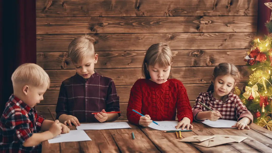 4 young children writing Christmas letters