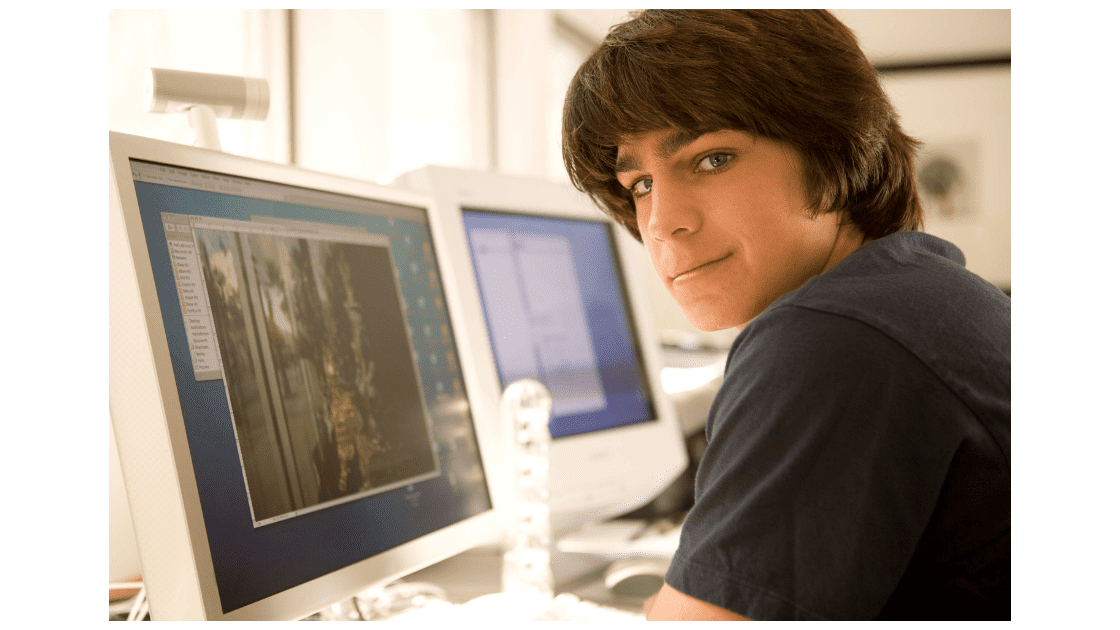 Teenage boy on computer coding