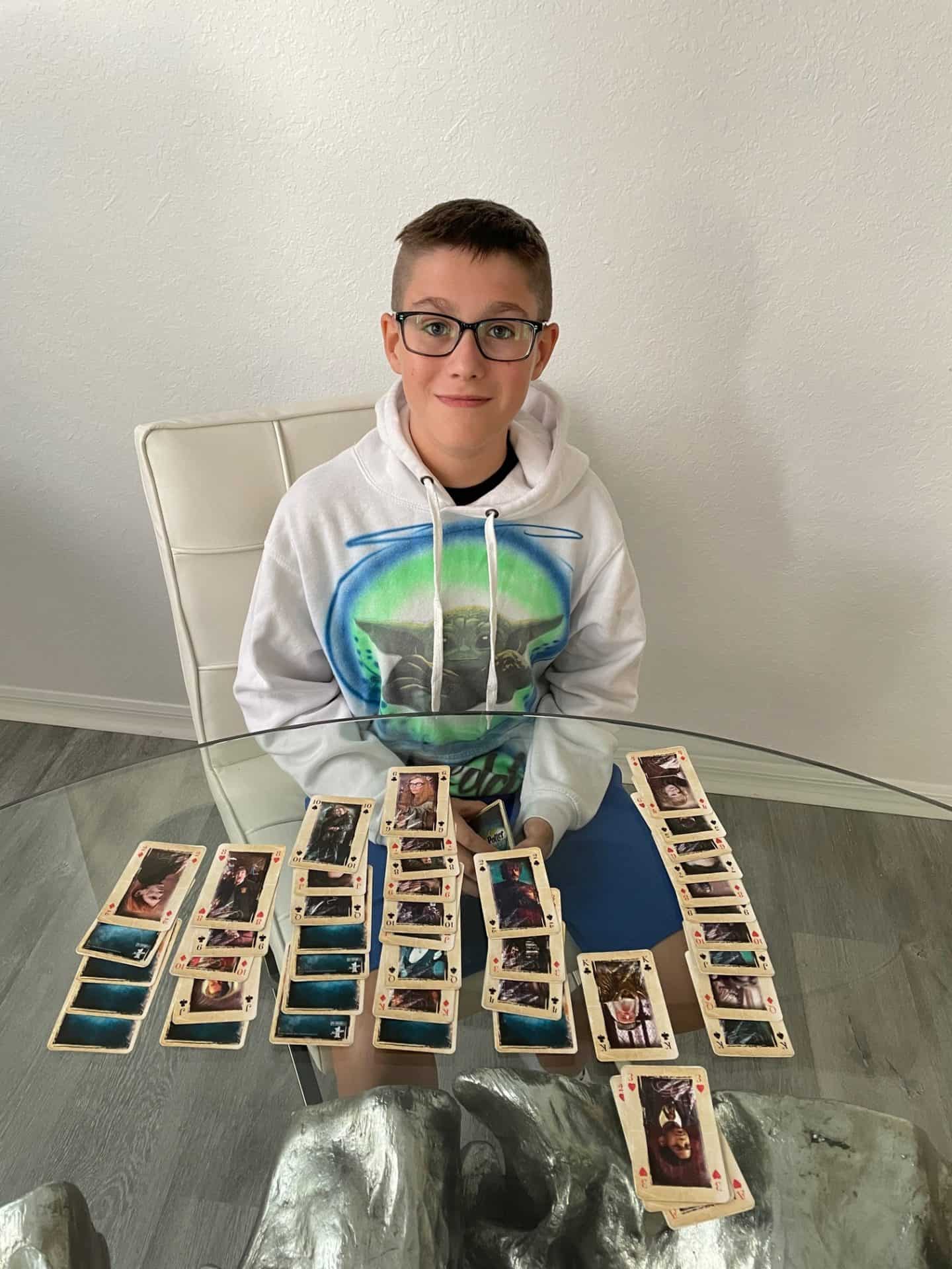 Boy playing solitaire on a table