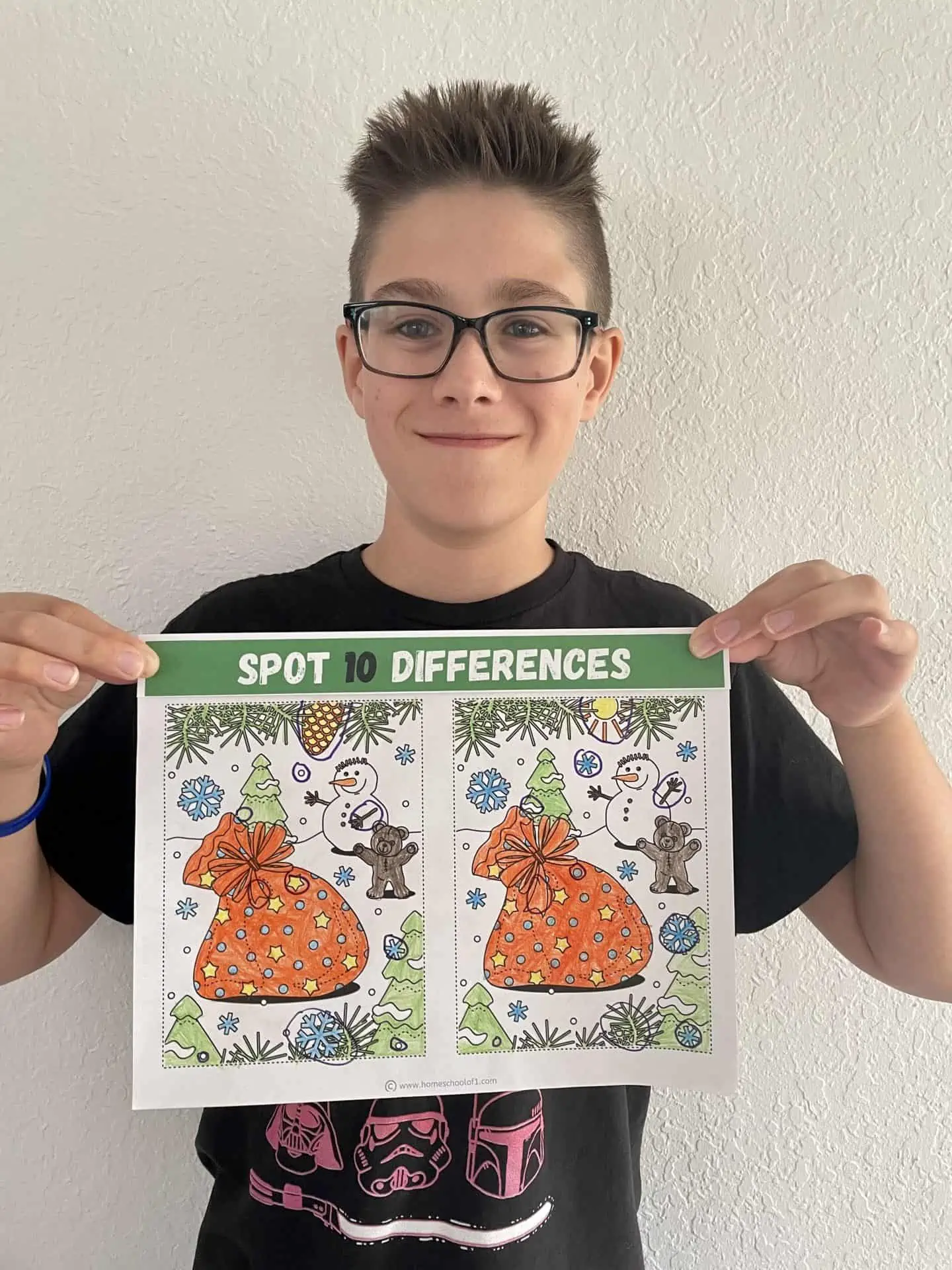 boy holding spot the difference coloring page