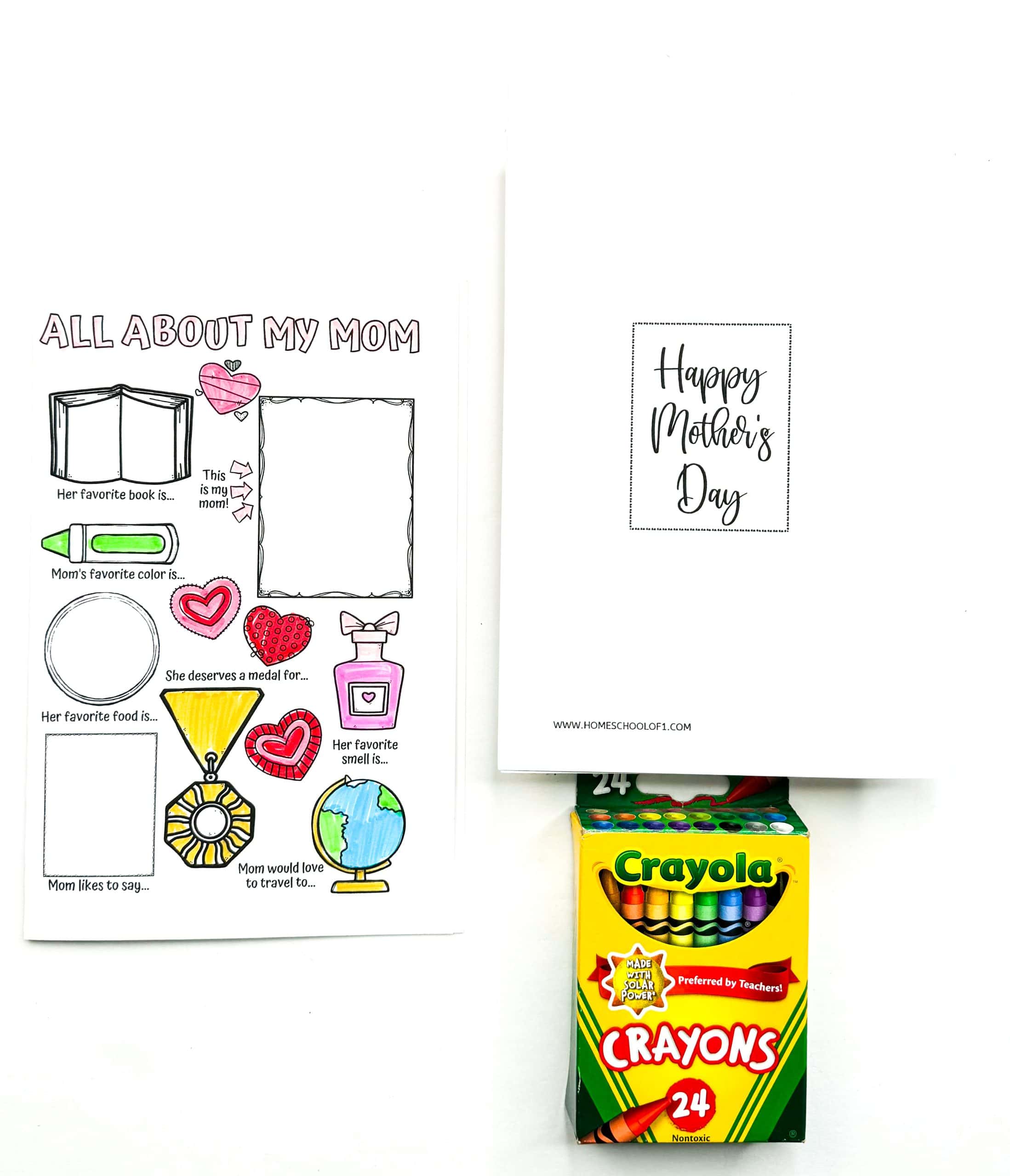 Mother’s Day activity sheet titled “All About My Mom” featuring prompts like “Her favorite book is...,” “Mom’s favorite color is...,” and “Mom would love to travel to...” alongside playful illustrations including a globe, medal, perfume bottle, heart, and crayon. A second card in the background reads “Happy Mother’s Day” in script, and a 24-pack of Crayola crayons is placed in front, suggesting this is a coloring activity for kids.