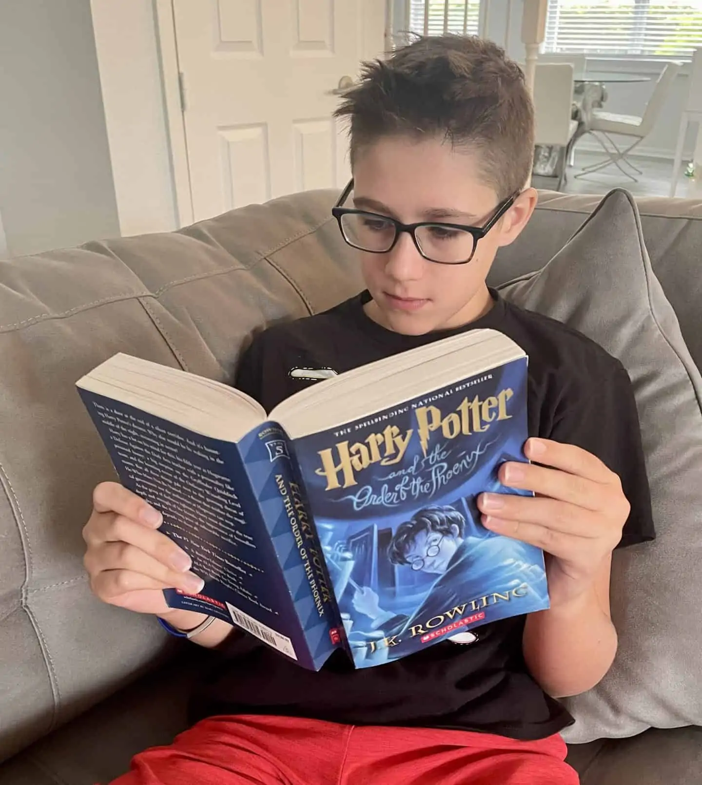 13 year old boy reading Harry Potter