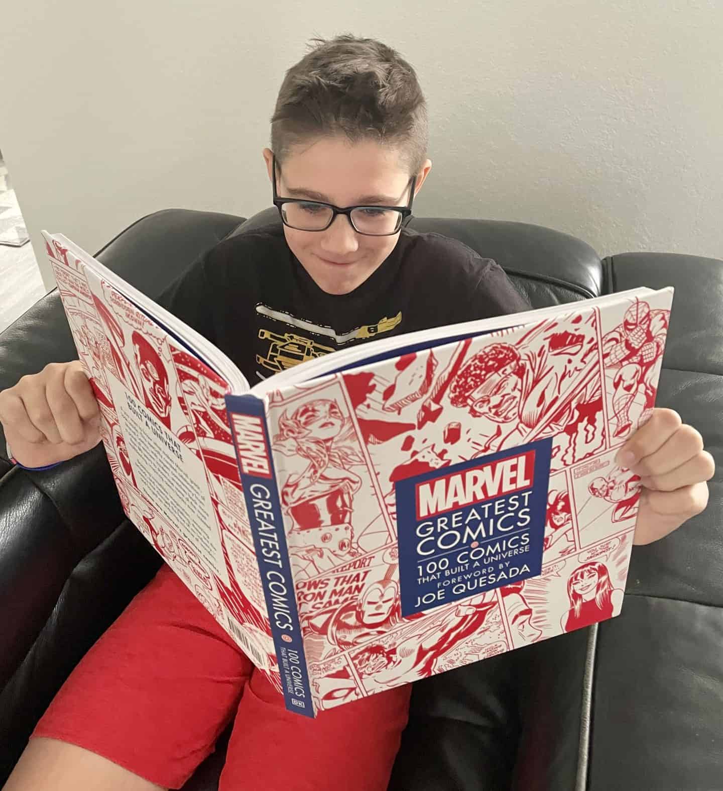 13 year old boy reading Marvel Greatest Comics book