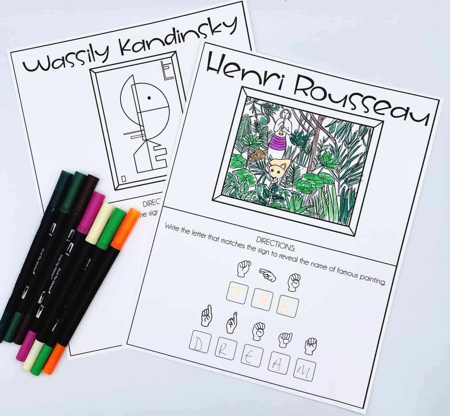Two ASL art-themed worksheets for kids. One features Henri Rousseau’s jungle painting “The Dream,” which is fully colored, with American Sign Language hand signs used to spell out “THE DREAM.” The other worksheet shows an outlined abstract artwork by Wassily Kandinsky. Several colored markers are laid diagonally across the pages.

