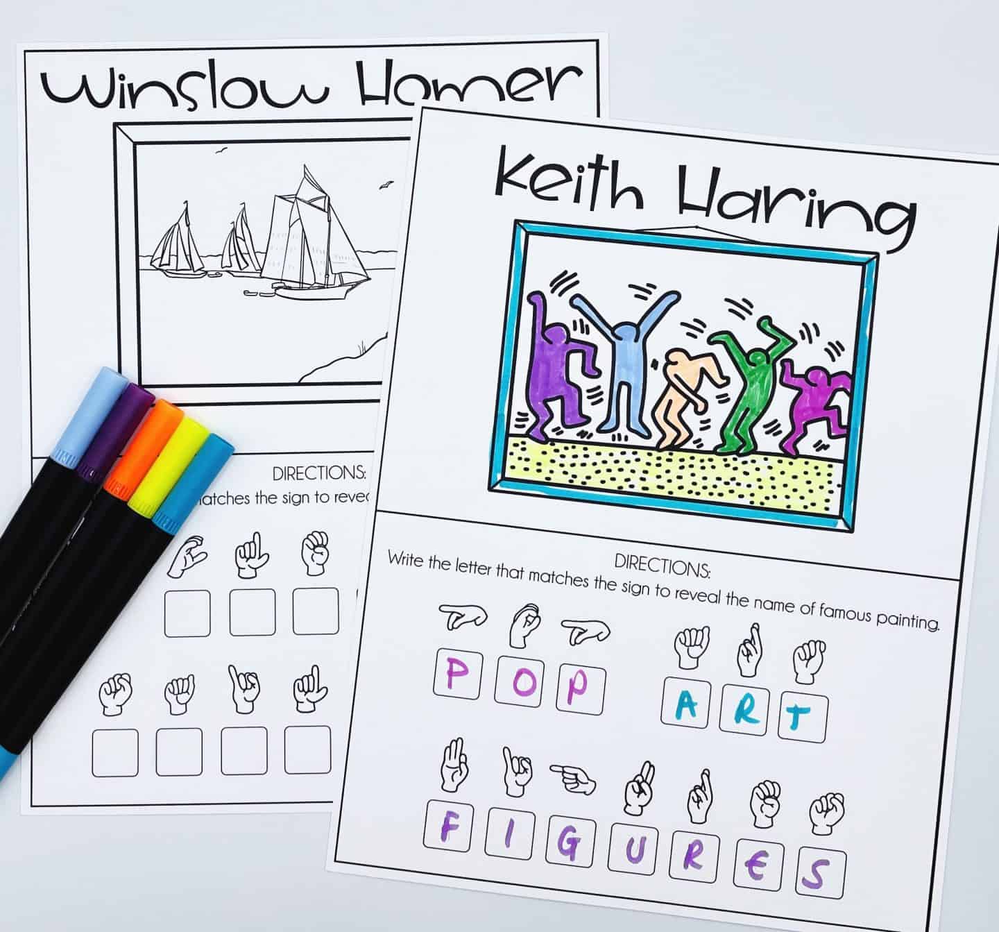 Two ASL worksheets featuring artists Keith Haring and Winslow Homer. The Keith Haring worksheet is colored with vibrant dancing figures and includes ASL signs spelling “POP ART FIGURES.” The Winslow Homer worksheet, uncolored, depicts sailboats on the water. Colorful markers are placed beside the pages.