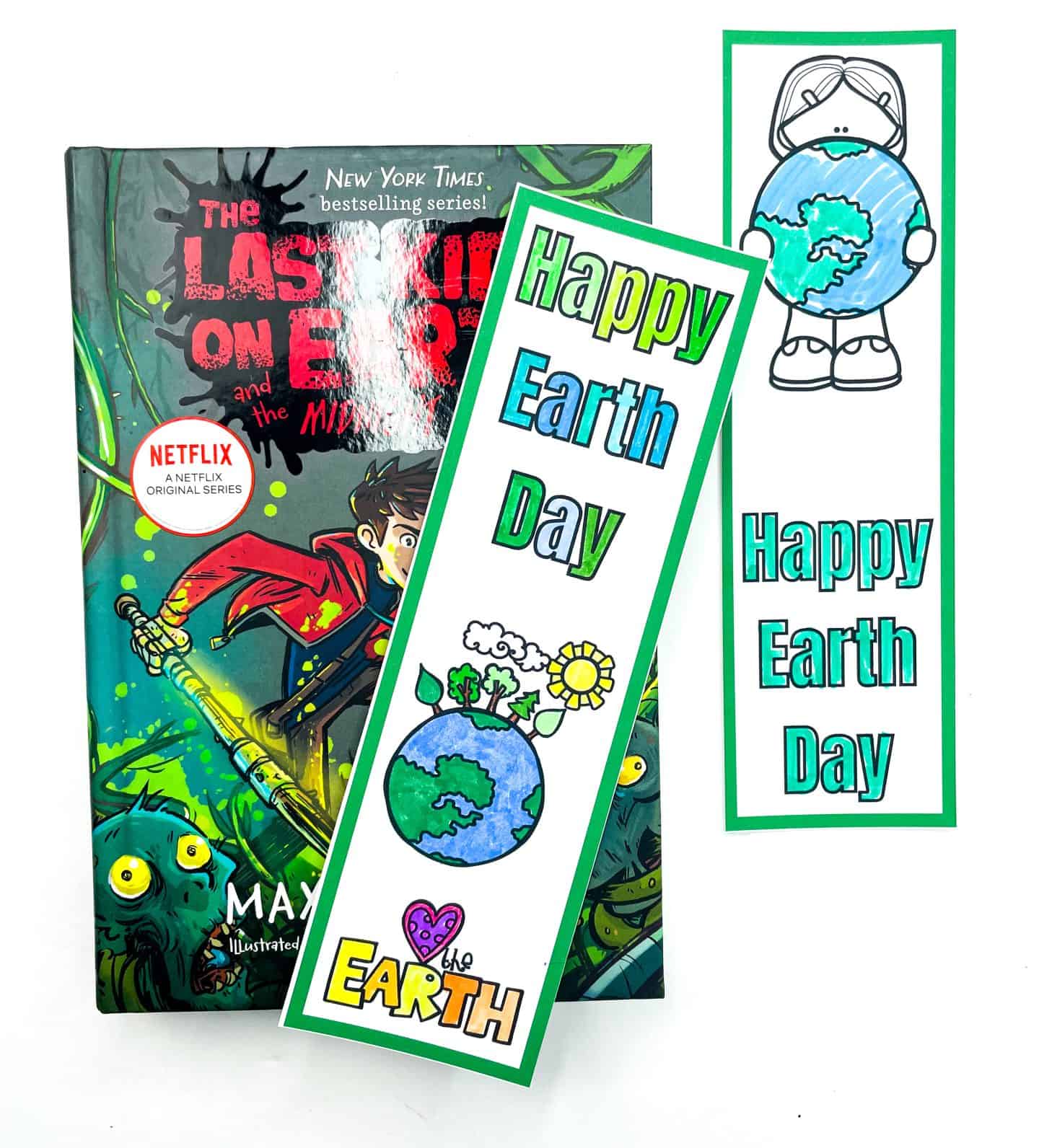A vertical collage showing Earth Day bookmarks both colored and blank, surrounding the book The Last Kids on Earth. Bold text in the center reads “FREE EARTH DAY BOOKMARKS,” emphasizing the printable and customizable nature of the designs.



