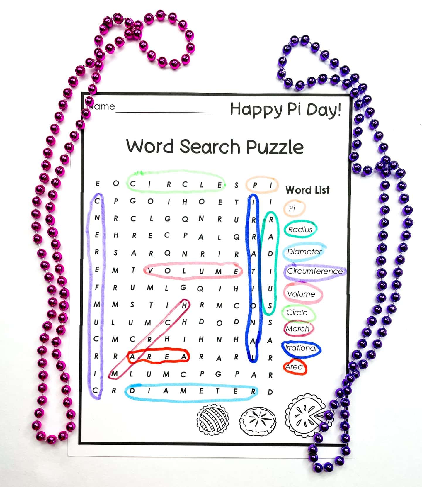 A Pi Day word search puzzle worksheet featuring math-related terms like "Pi," "Radius," "Diameter," "Volume," and more, with many words already highlighted in colored marker. The sheet is titled "Happy Pi Day!" and is decorated with small pie illustrations and festive pink and purple bead garlands around the border.