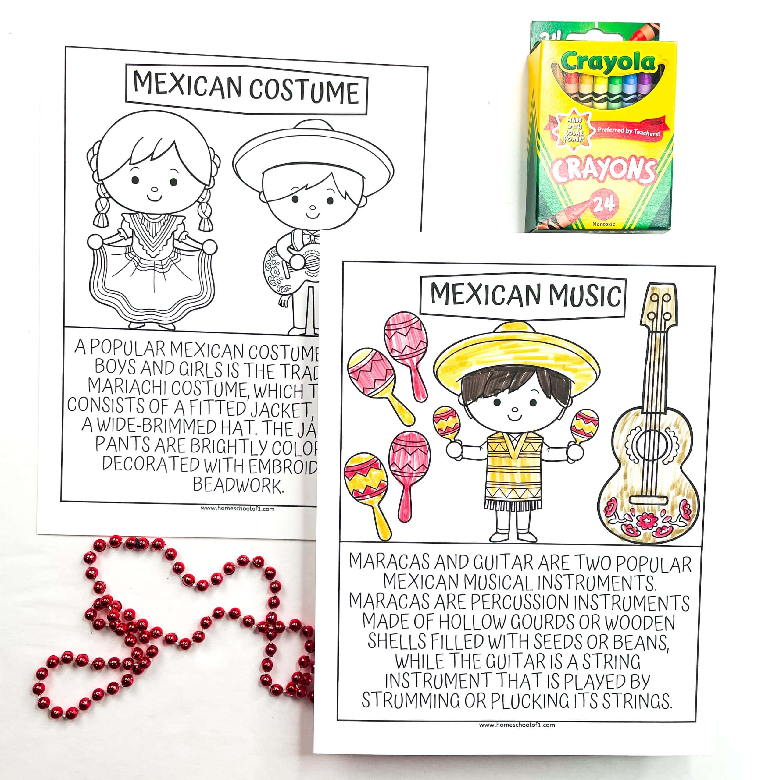 Two educational coloring pages for kids focused on Mexican culture. One page features a girl and boy in traditional mariachi attire with the heading “Mexican Costume” and a paragraph explaining the outfit’s components and vibrant embroidery. The other page, labeled “Mexican Music,” shows a child playing maracas next to a decorated guitar, along with text describing both instruments. A box of Crayola crayons and a red beaded necklace are included for a festive touch.