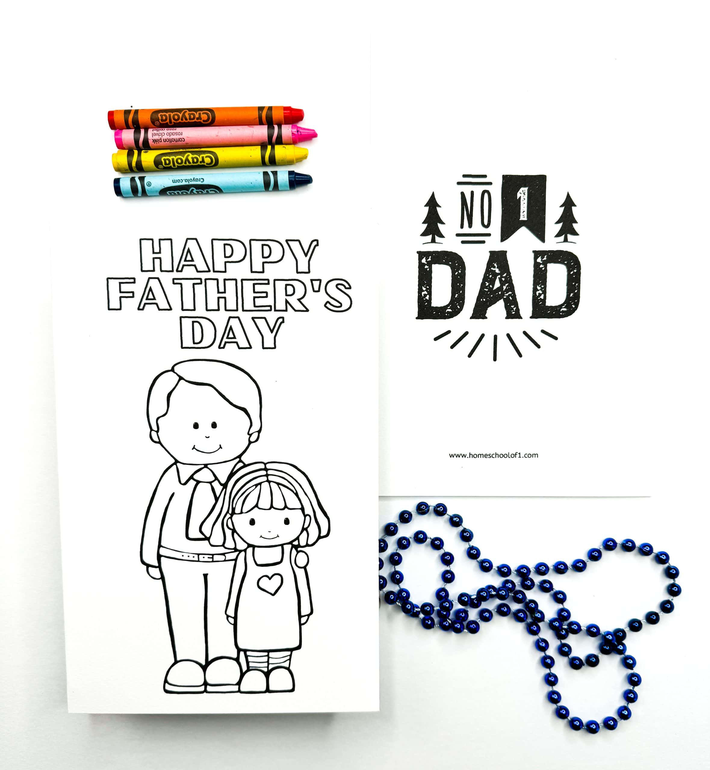 Black and white Father's Day coloring card with a father and daughter illustration below the words "Happy Father's Day." A second printable card says "No. 1 Dad" in bold black font. The scene includes five Crayola crayons and a blue beaded necklace for crafting.