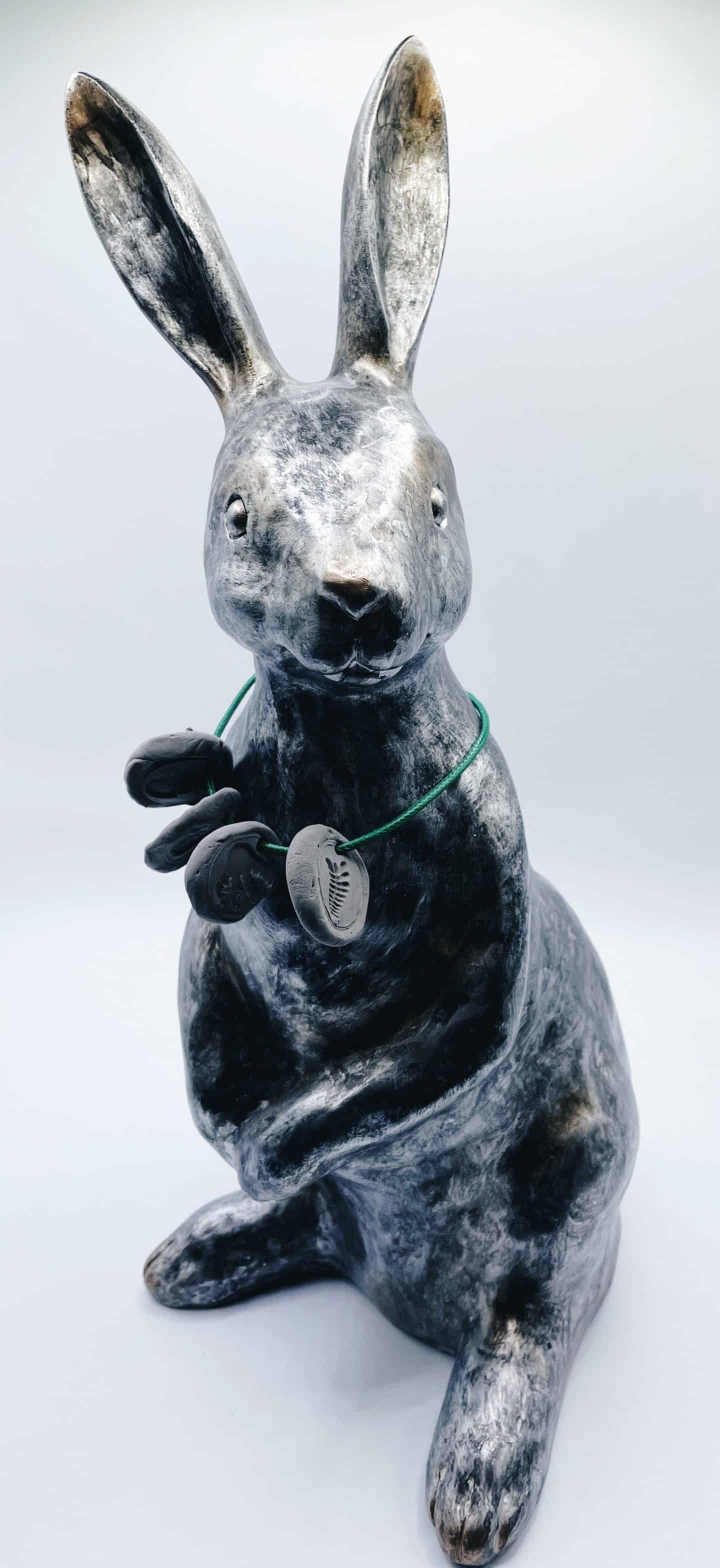 rabbit statue wearing fossil necklace