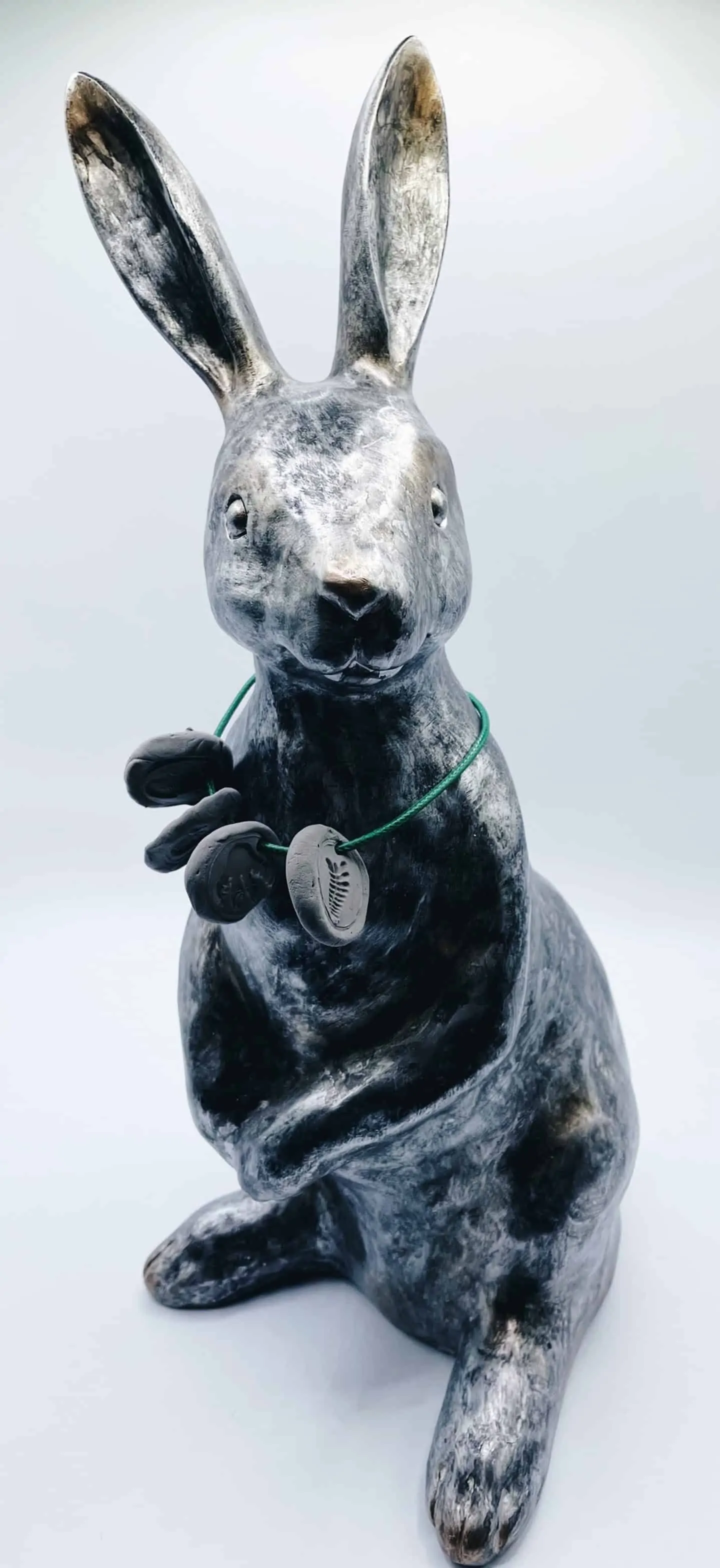 rabbit statue wearing fossil necklace