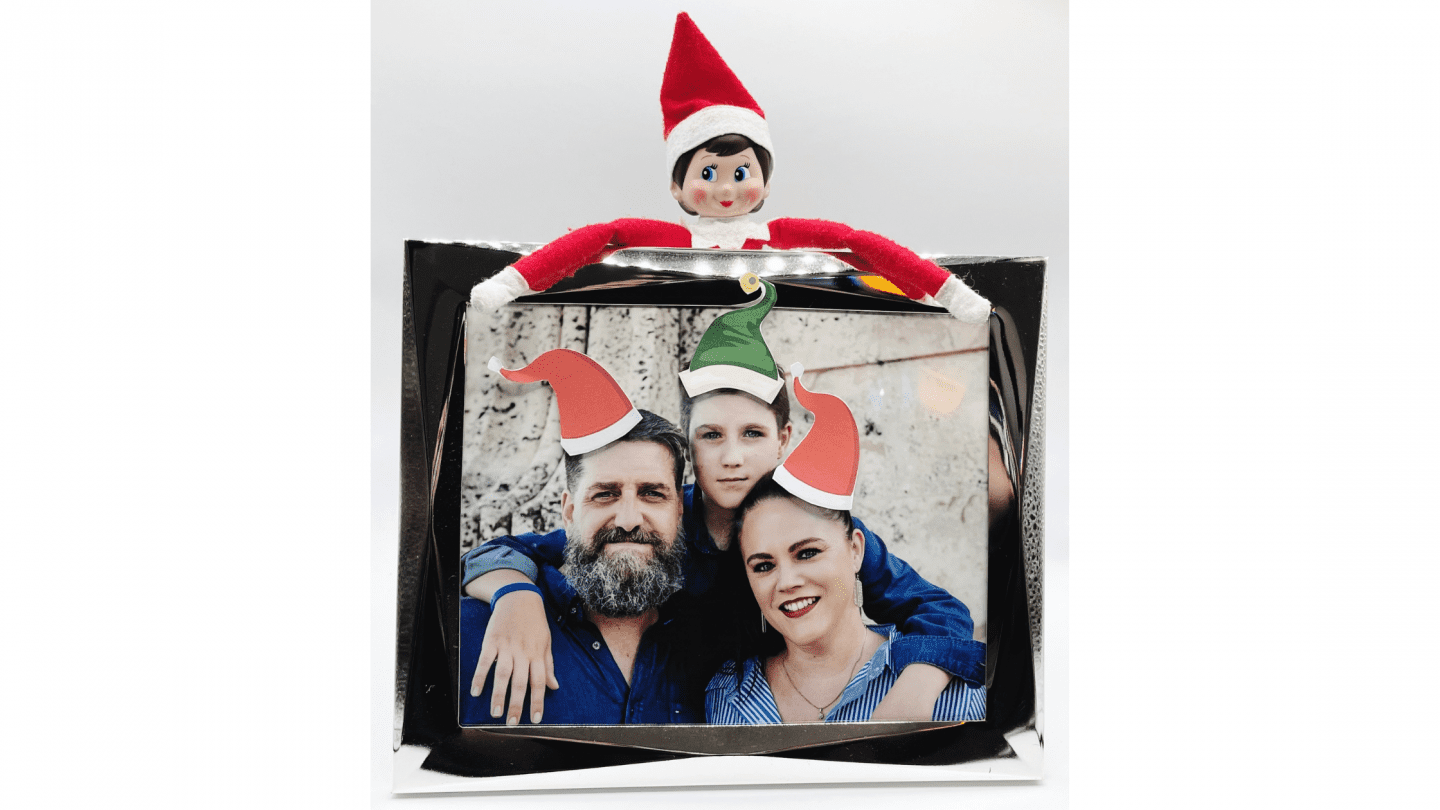 Elf on the Shelf hats on family photo