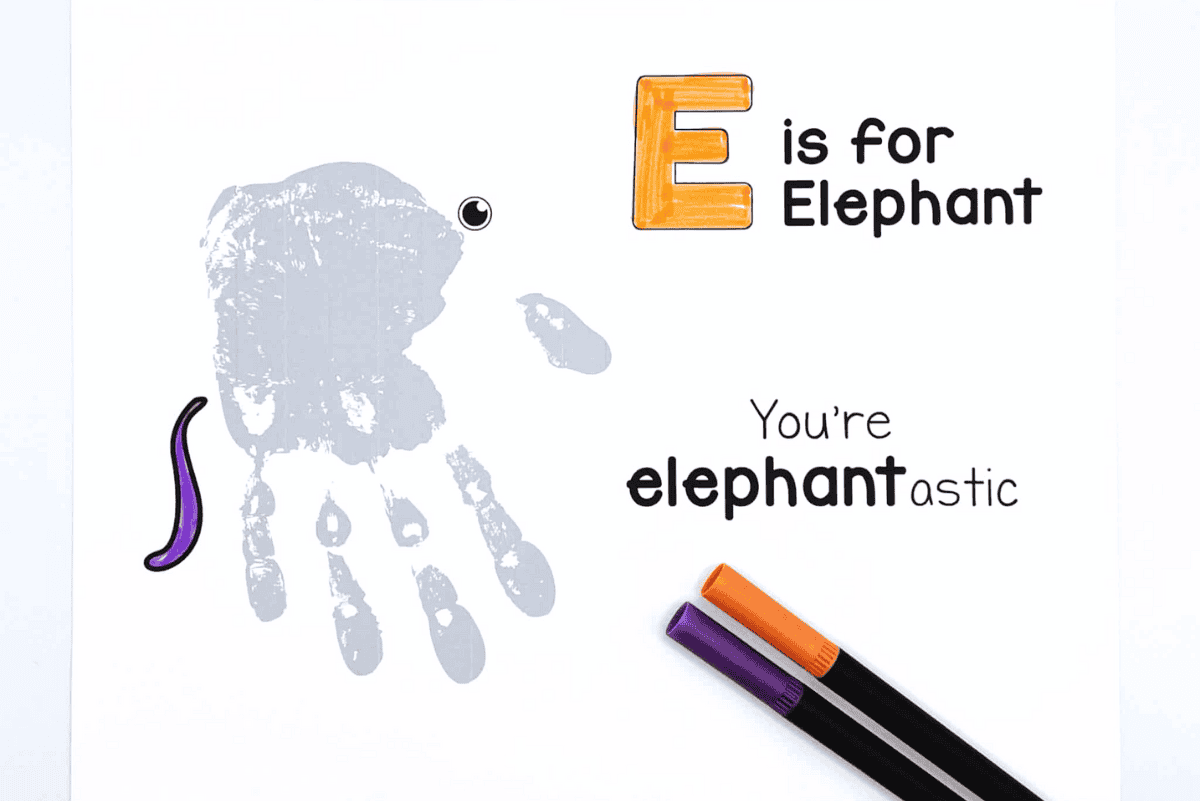 Kids’ elephant handprint craft with painted gray hand and free E is for Elephant template.