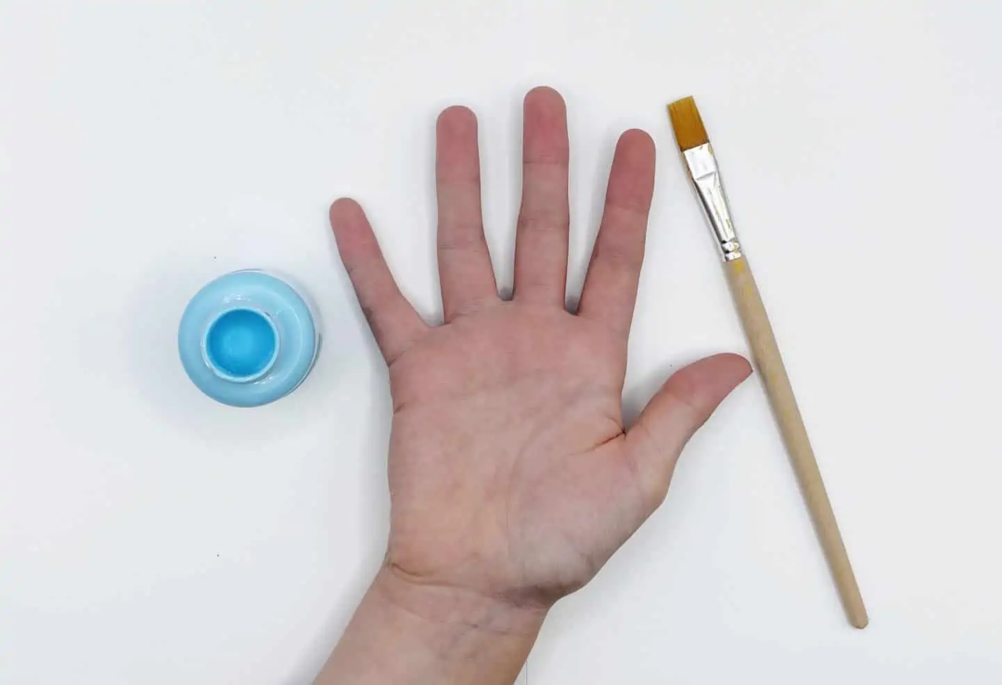 hand and blue paint