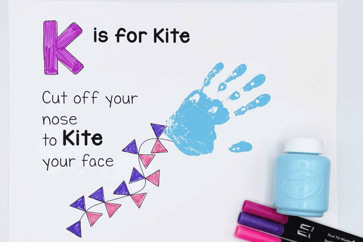 Kite handprint art for preschool featuring K is for kite printable with blue handprint and triangle-shaped kite tail decorations.