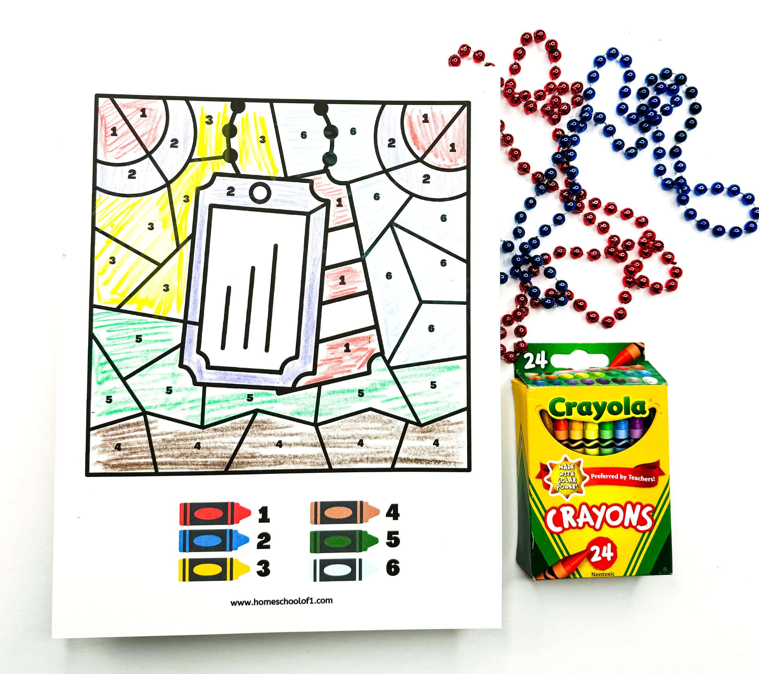 Military dog tags color by number, using 6 different colors, with red and blue beads and crayola crayons to the right hand side as decoration. 