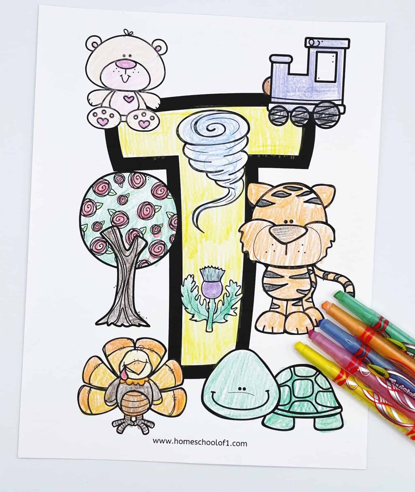 letter t coloring page with an uppercase T and a teddy a train, a tree, a thistle, a tiger, a turkey and a turtle colored in with crayons. twistables from crayola are laying on the page.