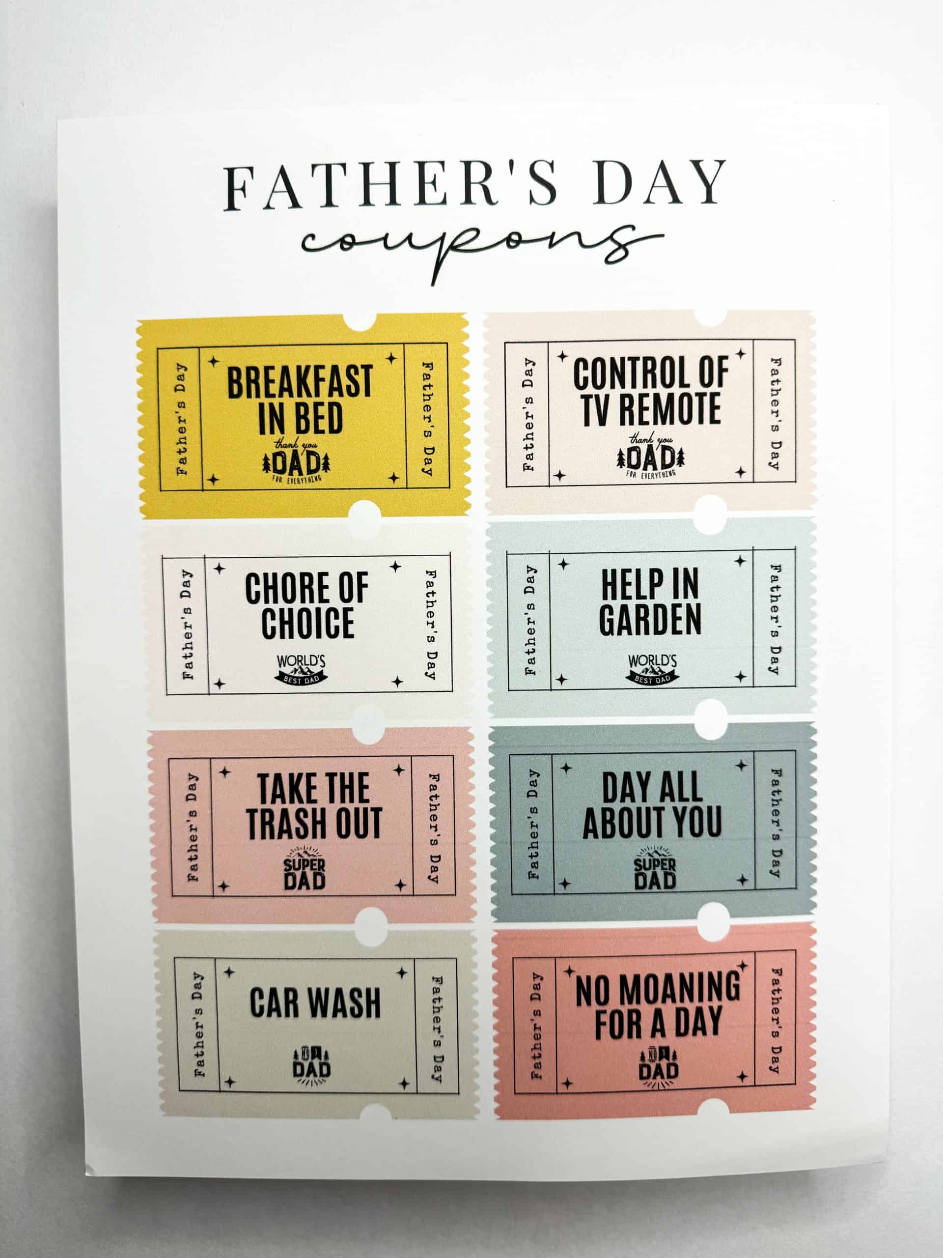 A sheet of printable Father's Day coupons titled "Father's Day coupons" in elegant black script. The sheet includes eight colorful tickets with playful rewards like “Breakfast in Bed,” “Control of TV Remote,” “Chore of Choice,” “Help in Garden,” “Take the Trash Out,” “Day All About You,” “Car Wash,” and “No Moaning for a Day.”