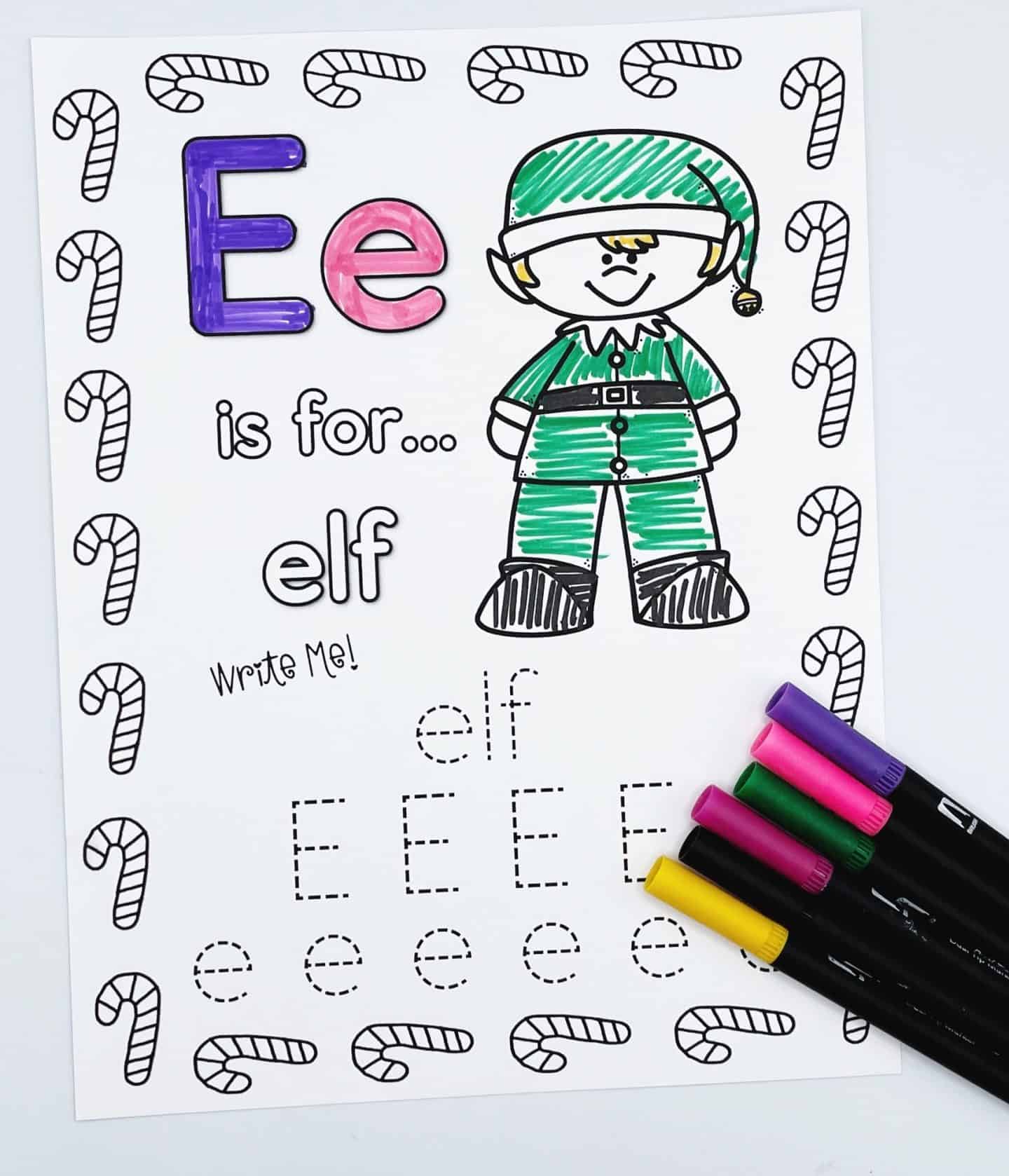 Christmas alphabet worksheet for the letter E, with the phrase “E is for… elf.” The page features a cheerful elf in a green outfit and hat, alongside traceable practice for the word "elf" and both uppercase and lowercase E’s. Candy canes decorate the border, and colorful markers are placed on the worksheet.