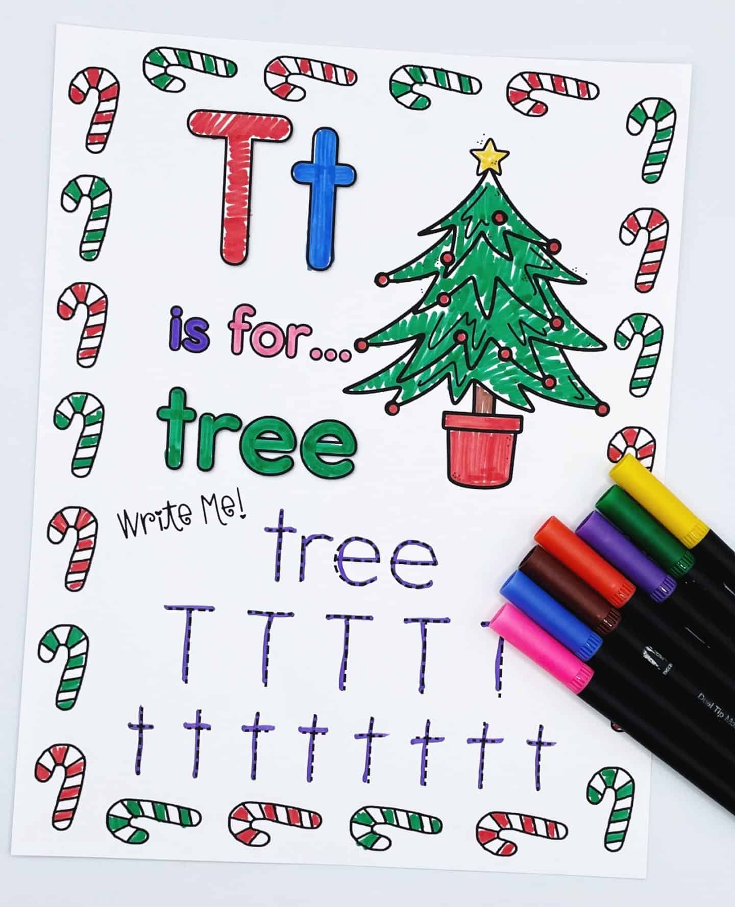 Christmas alphabet worksheet for the letter T, featuring the phrase “Tt is for… tree” with a decorated Christmas tree illustration. The word "tree" is in green, and tracing practice is provided for the word and uppercase and lowercase T’s. The page is bordered with colorful candy canes, and a set of markers is placed in the bottom right corner.