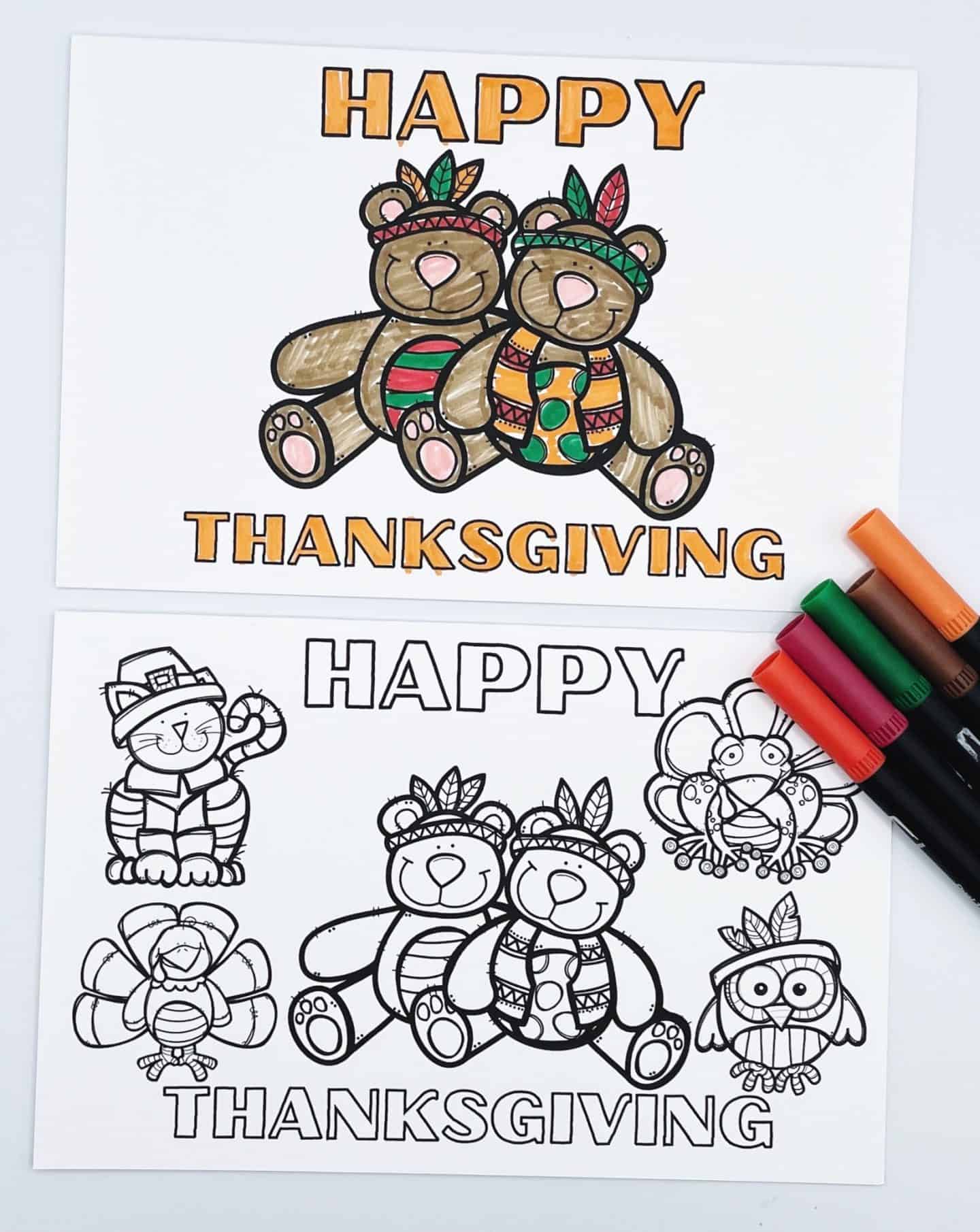 Two printable Thanksgiving cards to color are shown, one colored and one uncolored. The top card is fully colored and features two cute teddy bears dressed in Native American-style attire with the message "Happy Thanksgiving" in bold orange and yellow letters. The bottom card is uncolored and includes the same bears along with additional characters: a smiling cat, a turkey, and an owl, all in Thanksgiving-themed outfits. A set of markers in autumn colors lies next to the cards.