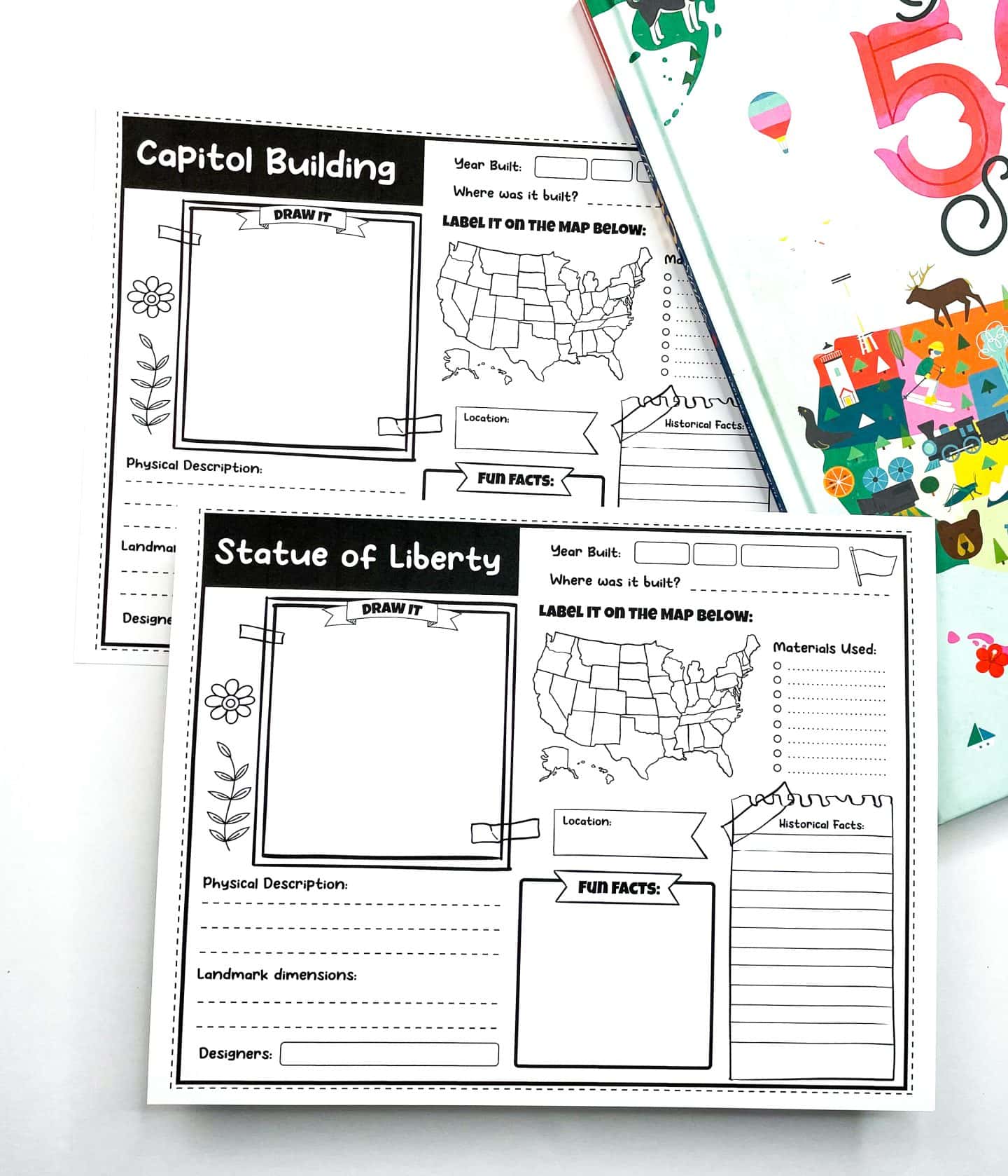 Two printable U.S. landmark worksheets for kids featuring the Capitol Building and the Statue of Liberty. Each worksheet includes a blank space to draw the landmark, a U.S. map to label the location, and sections for physical description, materials used, historical facts, fun facts, landmark dimensions, and designers. The pages are styled with simple floral and decorative elements and are placed beside a colorful “50 States” book.