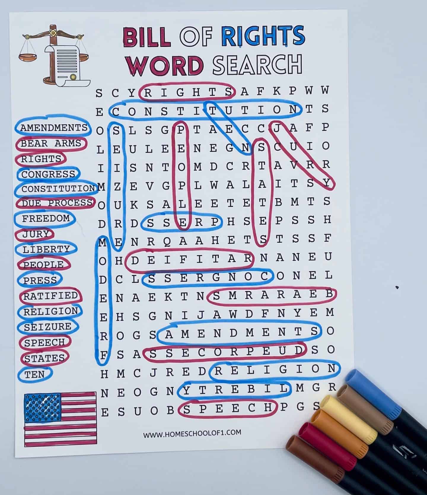 A printed “Bill of Rights Word Search” puzzle with 20 themed words like “speech,” “jury,” “press,” and “due process” circled in pink and blue, matching the color-coded word list on the left; the sheet includes a U.S. flag, a justice scale with a scroll, and is surrounded by five markers on the bottom right.