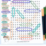 A colorful Greek mythology word search puzzle featuring names of gods and goddesses such as Aphrodite, Apollo, Ares, Artemis, Athena, Demeter, Dionysus, Hades, Hera, Hermes, Jupiter, Mars, Mercury, Neptune, Pluto, Poseidon, Venus, and Zeus. Each name is circled in various colors within the grid, and markers are placed beside the worksheet. The heading "Greek Mythology Word Search" appears in large, multicolored letters at the top.