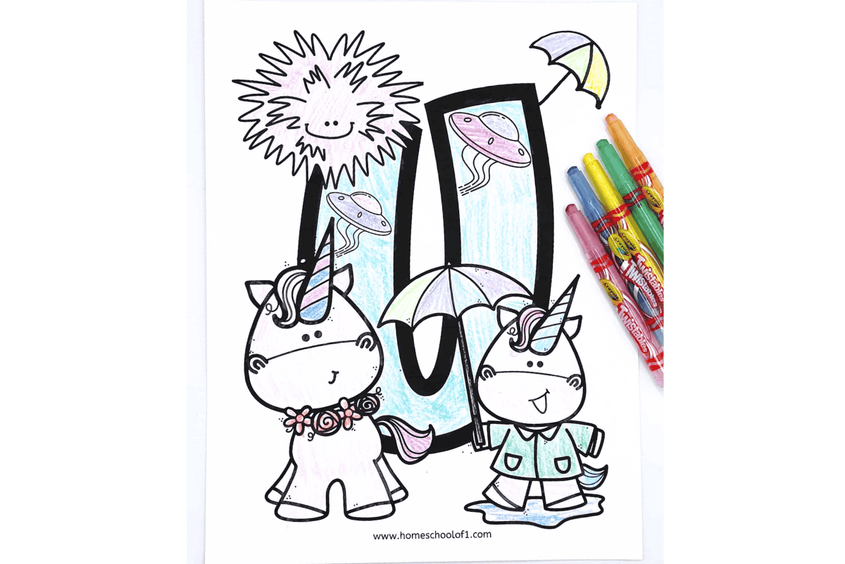 Letter U coloring sheet with unicorns, umbrella, UFOs, and an urchin, shown partly colored with markers.