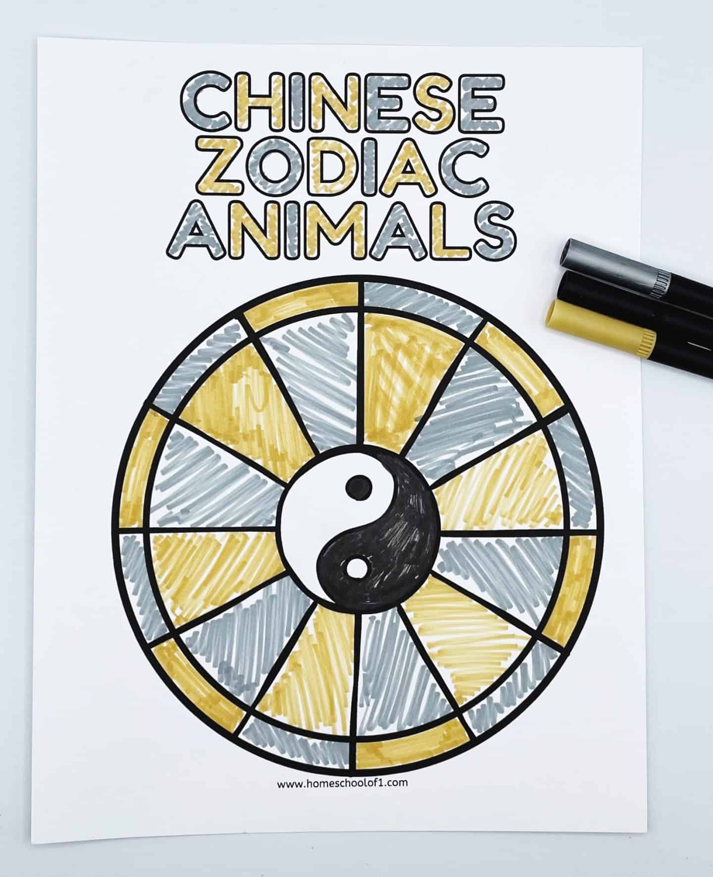 A Chinese Zodiac Animals coloring page featuring a yin-yang symbol in the center of a circular zodiac chart. The sections of the chart alternate between gold and silver colors, and the title “Chinese Zodiac Animals” is colored in matching shades above the circle. Three markers—silver, gold, and black—are placed to the right of the page.