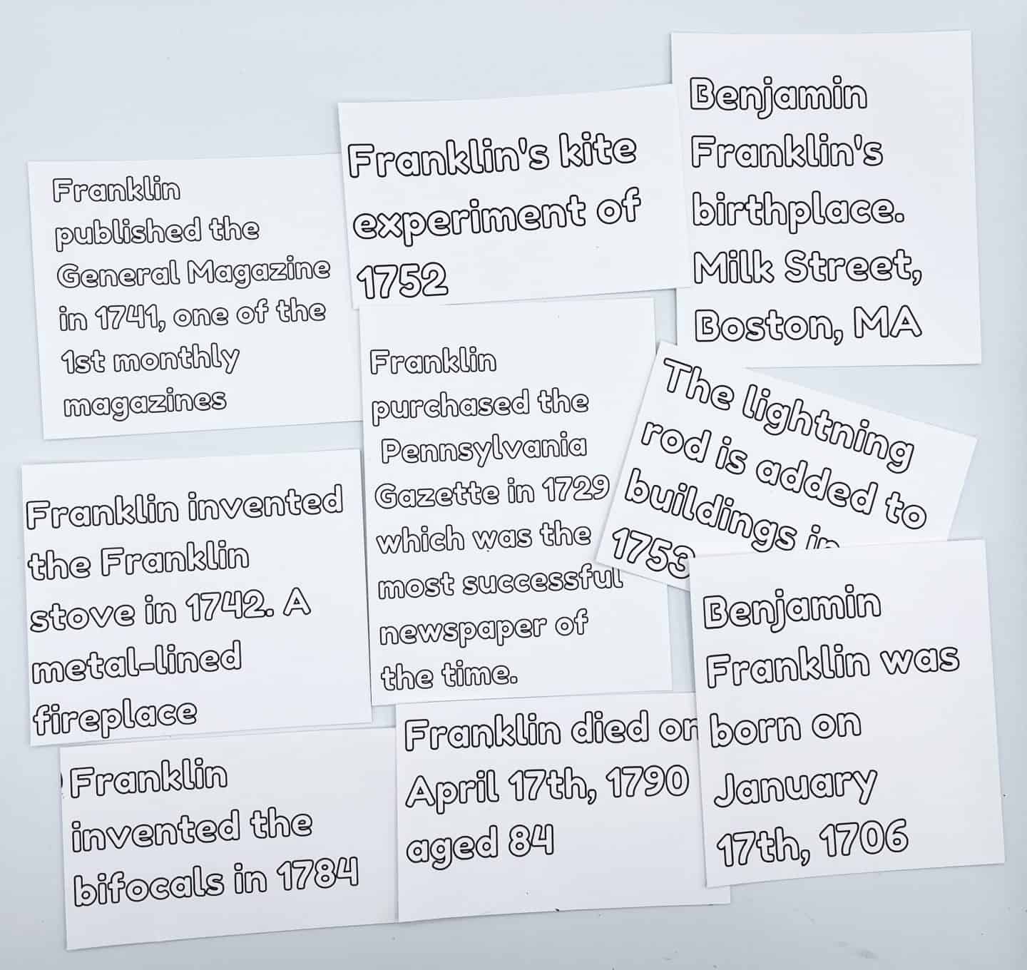 A set of cut out Benjamin Franklin timeline cards featuring his birth, death and everything in between.