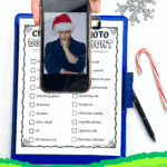 Free printable Christmas photo scavenger hunt shown on clipboard with candy cane, snowflake decoration, pen, and phone displaying Santa hat selfie.