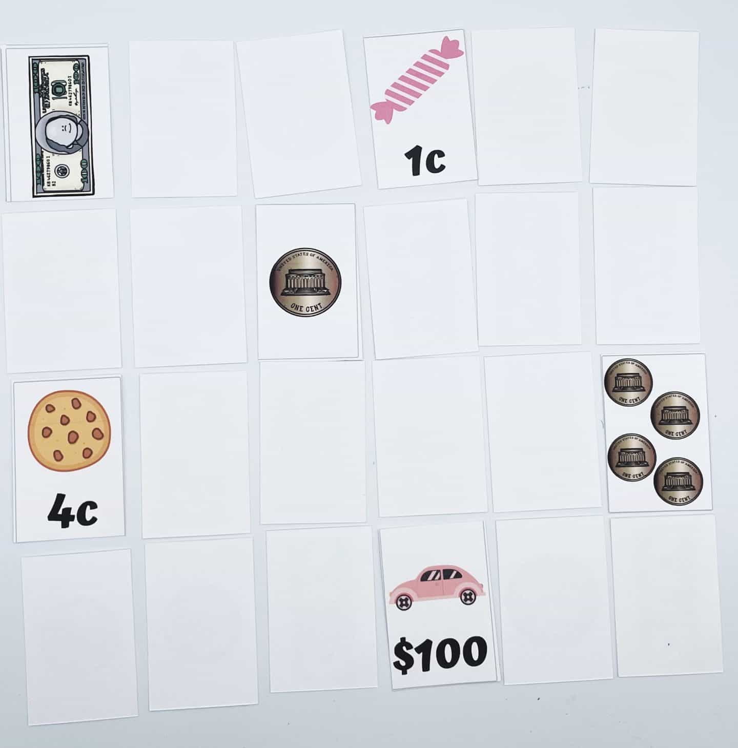 A memory matching game in progress featuring printable cards with images of U.S. currency and items. Some cards are flipped, revealing a $1 bill, a 1¢ candy, a 4¢ cookie, a penny coin, and a $100 pink car. Most cards remain face-down on the white playing surface.