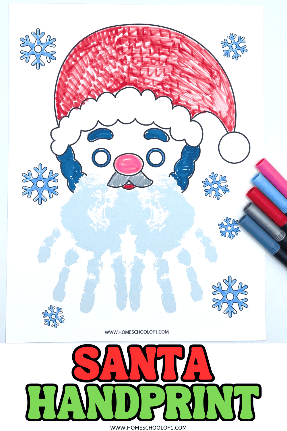 Santa handprint craft with a red hat and blue handprint beard, surrounded by snowflakes and markers.

