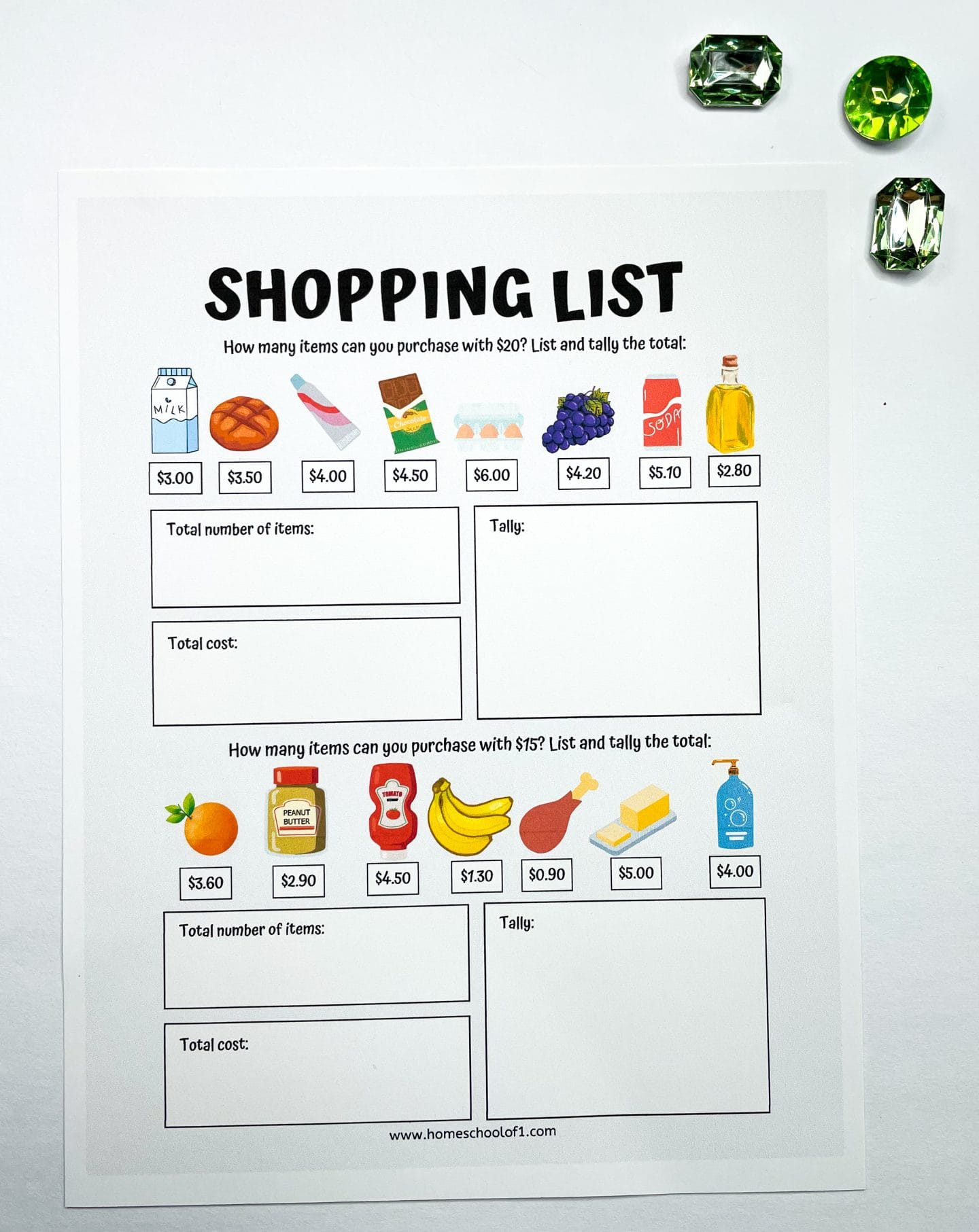 A printable worksheet titled "Shopping List" features two money challenges for kids. The top section asks how many items can be bought with $20, showing images and prices of groceries like milk ($3.00), bread ($3.50), chocolate ($4.50), eggs ($6.00), grapes ($4.20), and more. The bottom section poses the same question with a $15 budget, listing items like oranges ($3.60), peanut butter ($2.90), ketchup ($4.50), bananas ($1.30), and others. Each section includes boxes to tally item quantities and calculate total costs. Green gem decorations are visible at the top right corner.