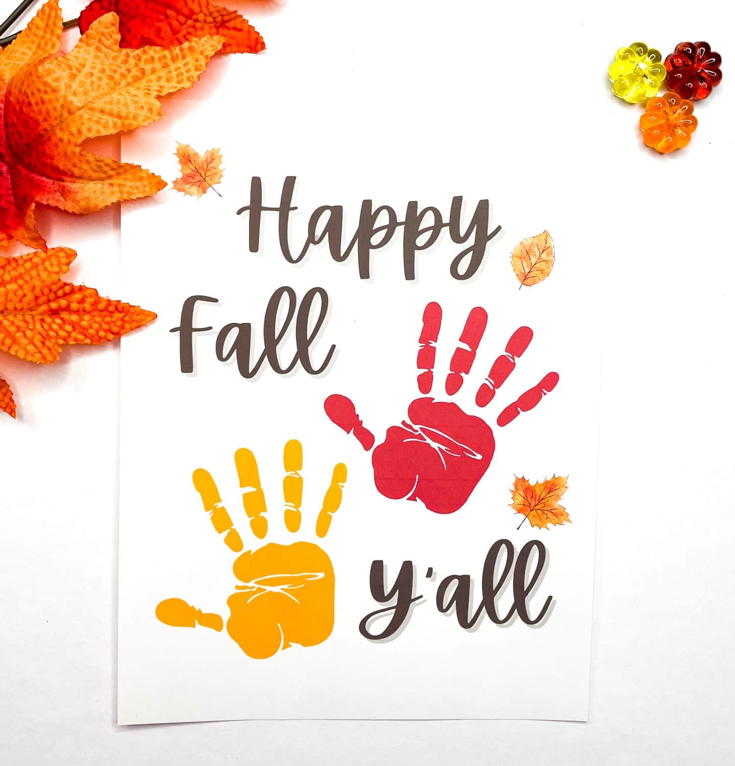 thanksgiving handprint happy fall y'all with a red and yellow handprint looking like fallen leaves. 
