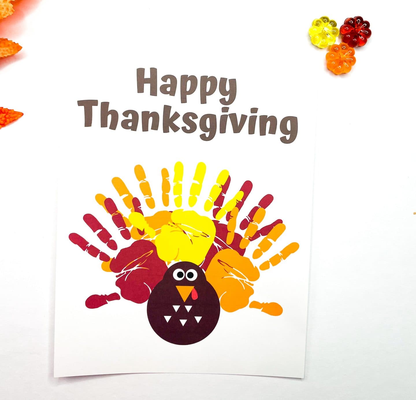 completed thanksgiving handprint turkey with yellow red and orange handprints as the tail of the turkey