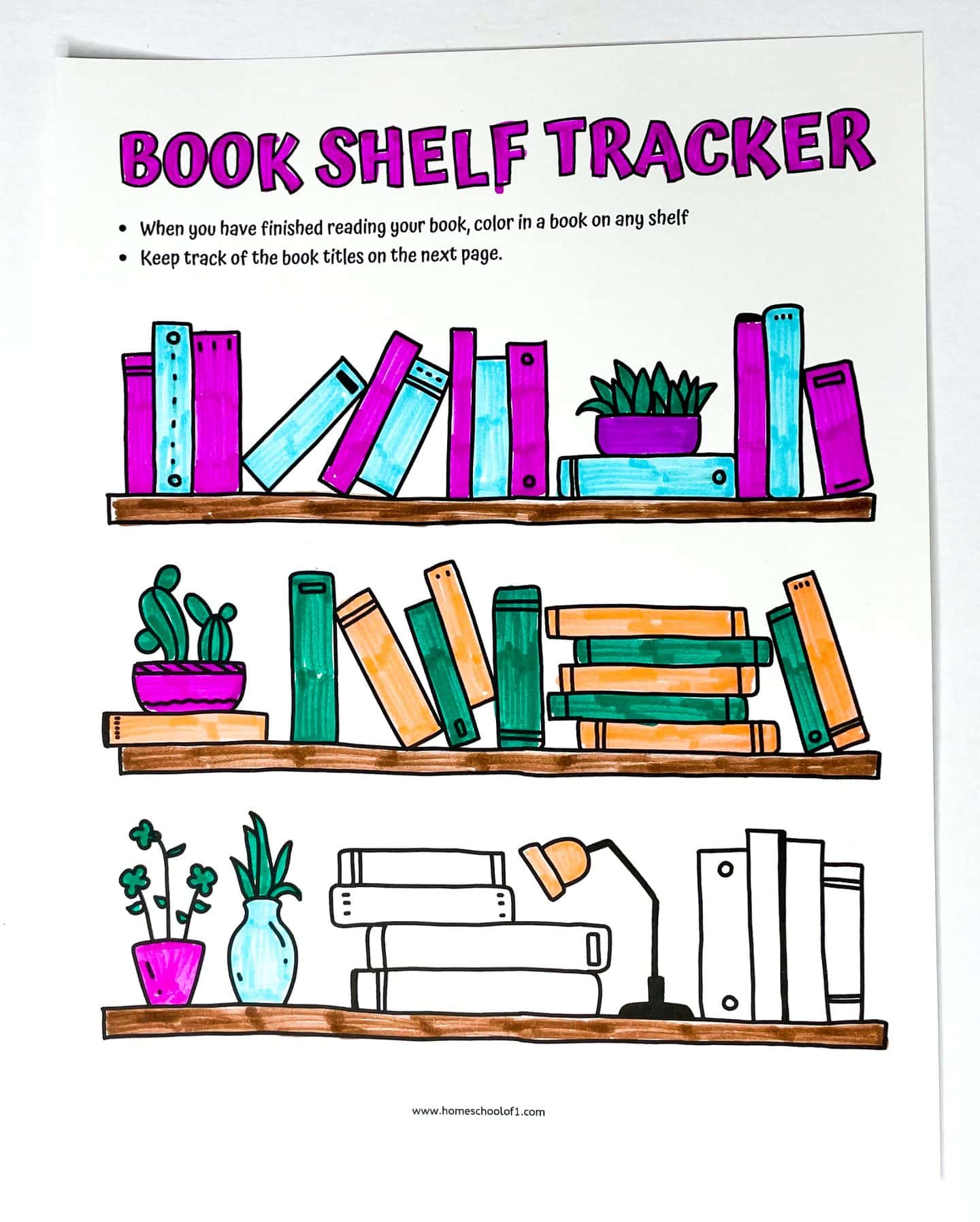 A “Book Shelf Tracker” printable with three illustrated wooden shelves filled with books, plants, and a lamp. Several books on the shelves are colored in bright shades of pink, teal, green, and orange, indicating completed reads. Instructions at the top encourage coloring in a book after finishing it and tracking titles on the next page.