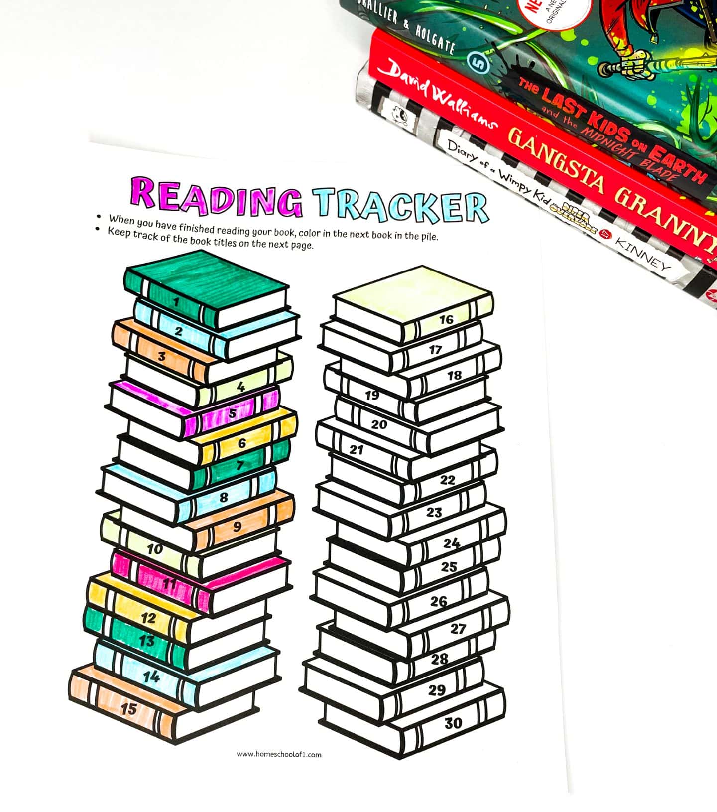 A colorful “Reading Tracker” printable featuring two tall stacks of numbered books from 1 to 30, with books 1 to 15 partially colored in. The top of the sheet provides instructions to color a book after finishing a read. A few children’s books, including Diary of a Wimpy Kid and Gangsta Granny, are visible in the top corner.