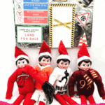 Elf construction zone display with warning signs and elves in sports-themed outfits.