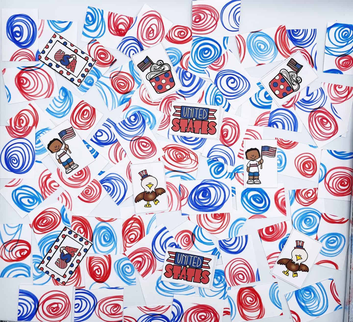 Fourth of July memory game cards laid face down with red and blue swirl patterns, some flipped to reveal patriotic images including an eagle in a top hat, “United States” text, a child holding an American flag, a cupcake with a flag topper, and a heart with stars and stripes.
