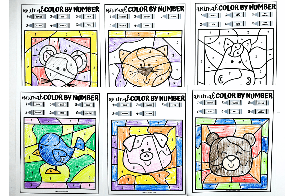 A collection of six animal color by number worksheets for kids, showing cartoon animals including a koala, cat, pig, bird, and bear. Four pages are fully colored using crayons according to the numbered color key, while two remain uncolored. Each worksheet features a grid-style layout with large, simple sections ideal for early learners.