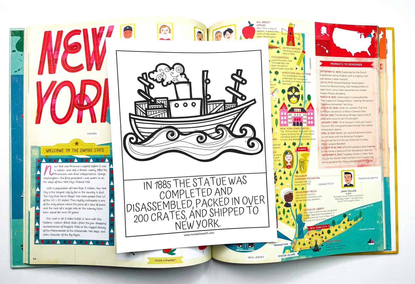 A black and white coloring worksheet showing a steamship carrying crates, placed on top of an open book about New York. The worksheet caption reads: “In 1885 the statue was completed and disassembled, packed in over 200 crates, and shipped to New York.” The background book features colorful illustrations and facts about New York state.