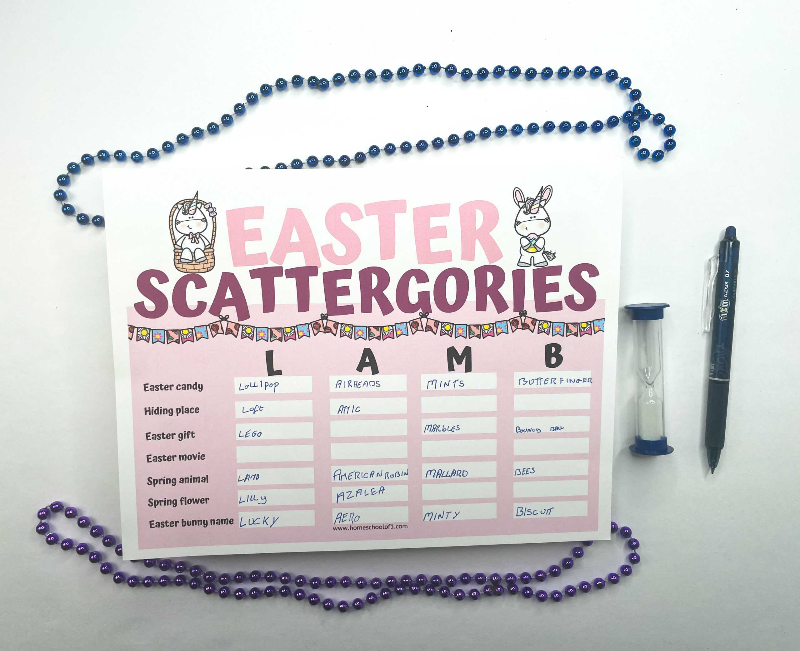 A single Easter Scattergories sheet with the word "LAMB" at the top, placed on a table next to a a blue pen and a timer. 