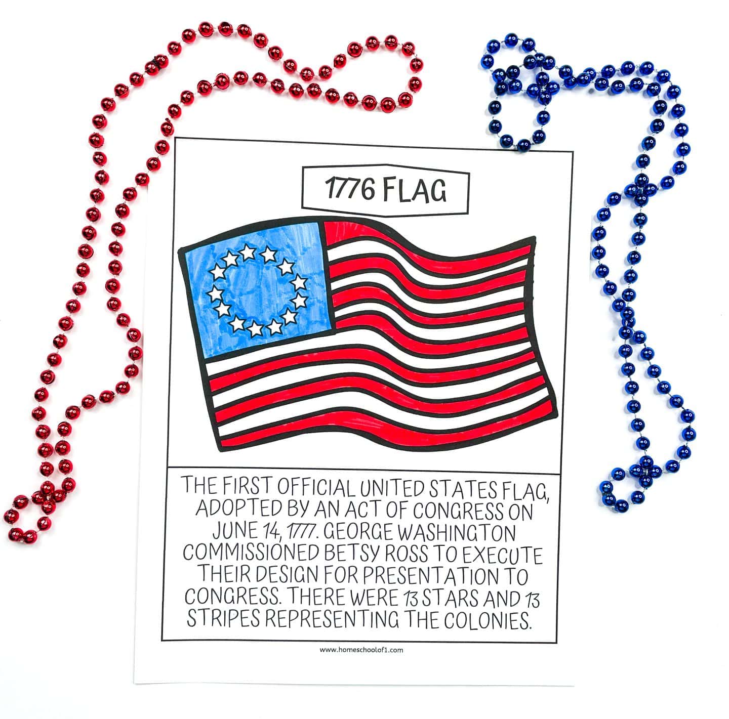 A coloring page of the 1776 American flag with 13 red and white stripes and a blue field featuring 13 white stars arranged in a circle. The page includes a caption explaining it was the first official U.S. flag, adopted on June 14, 1777, and designed by Betsy Ross at the request of George Washington. Red and blue beaded necklaces frame the top and sides of the page.